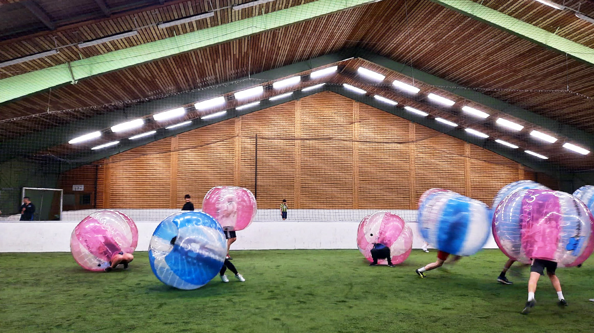 several people engaged in a bubble footbal match (Photo)