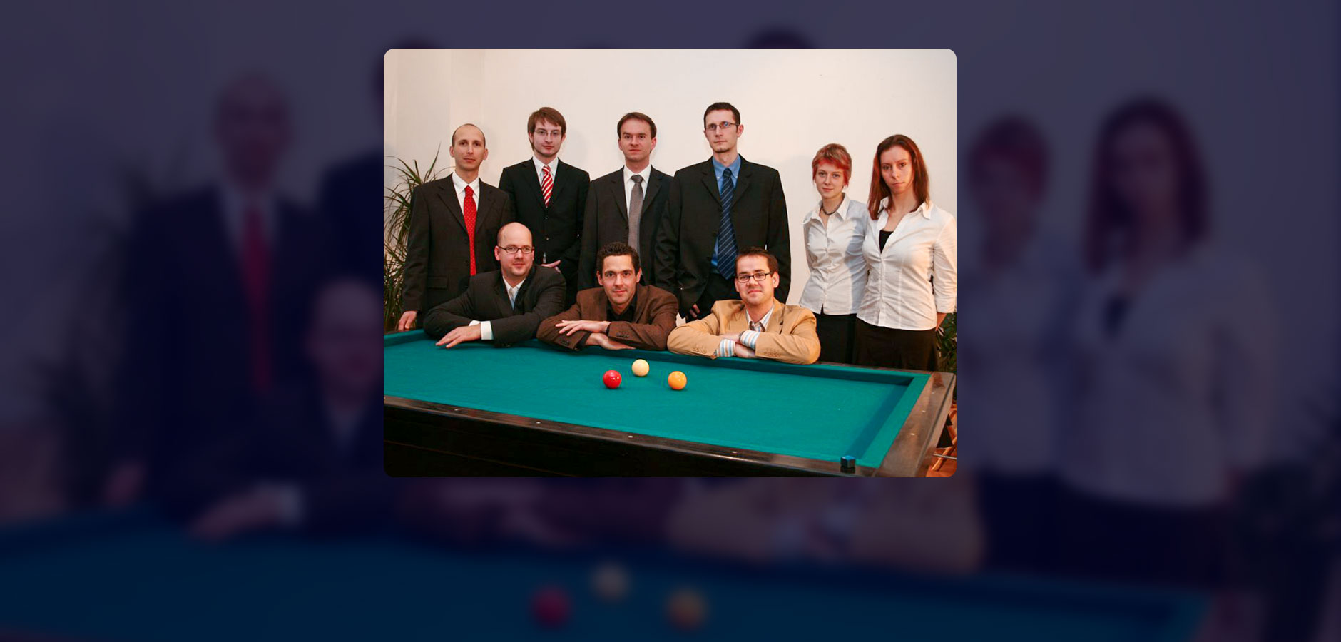 all nine employees together behind a billard table (Photo)